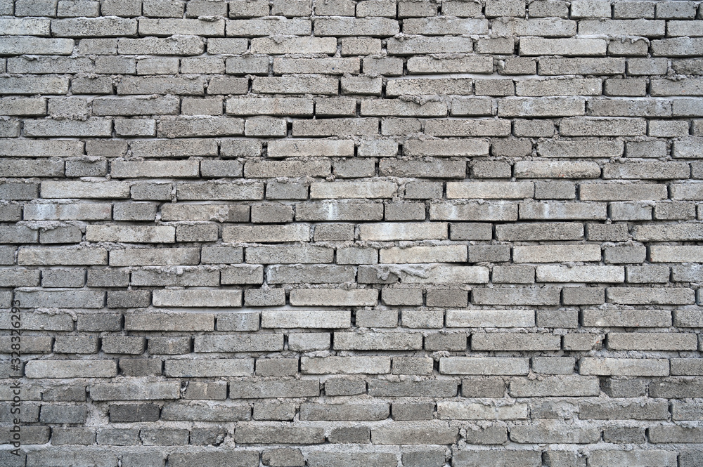 Obraz premium Rough dark gray building brick wall background