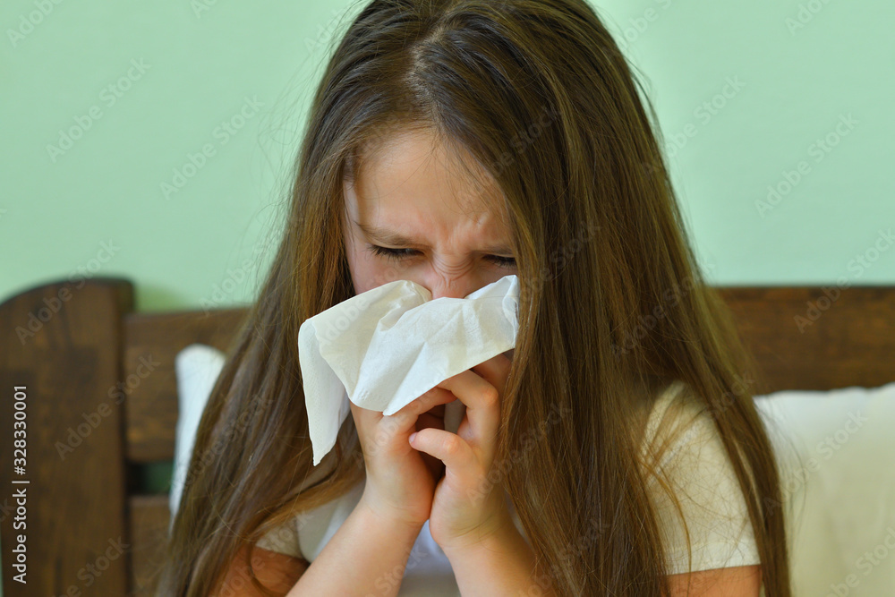 Little child girl blow his nose.Sick child with napkin in bed. Allergic kid, flu season. Kid with cold rhinitis, get cold snot nose. virus and infection Little child girl blow his nose.Sick child with napkin in bed. Allergic kid, flu season. Kid with cold rhinitis, get cold snot nose. virus and infection
