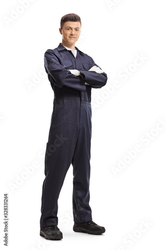 Young guy in an overall worker uniform posing and smiling