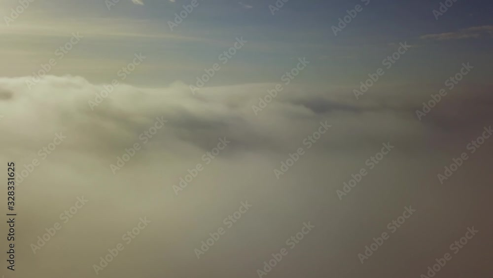 Drone flying above clouds. Thick clouds float below. Drone flying above clouds. Thick clouds float below.