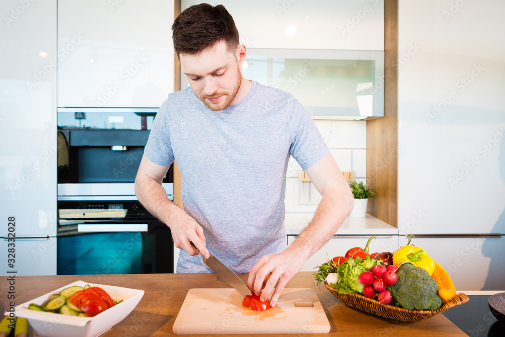 young happy man preparing food at home young happy man preparing food at home