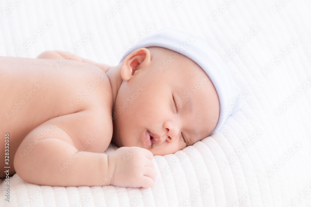Adorable Asian newborn baby deeply sleeping smile Easter costume hat, tiny infant boy soft skin healthy sleep dream on white blanket on bed beautiful sun light, newborn baby health care concept Adorable Asian newborn baby deeply sleeping smile Easter costume hat, tiny infant boy soft skin healthy sleep dream on white blanket on bed beautiful sun light, newborn baby health care concept