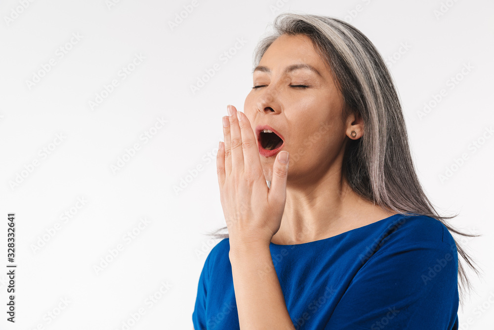 Image of adult mature sleepy woman with long gray hair yawning Image of adult mature sleepy woman with long gray hair yawning