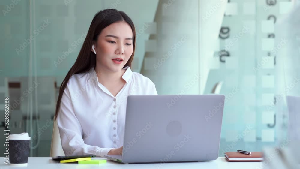 4k video of Boost mood at work. Joyful asian woman listening music by wireless earphone singing and dancing Cheerfully at the office. having fun. 4k video of Boost mood at work. Joyful asian woman listening music by wireless earphone singing and dancing Cheerfully at the office. having fun.