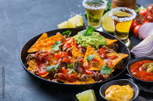 Chips nachos with beef  guacamole  chili  cheese salsa  tequila