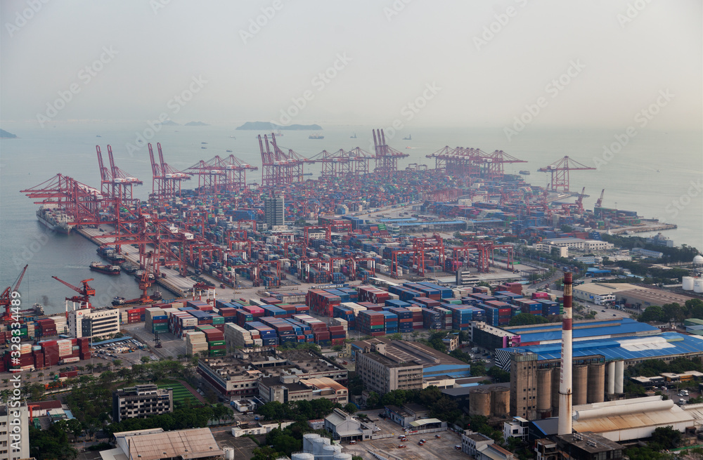 cranes load cargo vessels in Port of Shenzhen