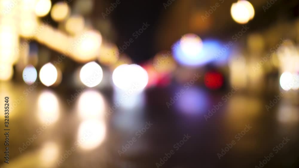 Out of focus approaching car on the night street Out of focus approaching car on the night street