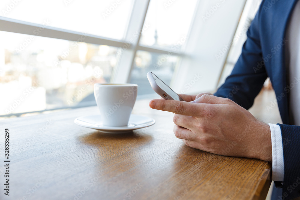 Handsome young businessman using mobile phone Handsome young businessman using mobile phone