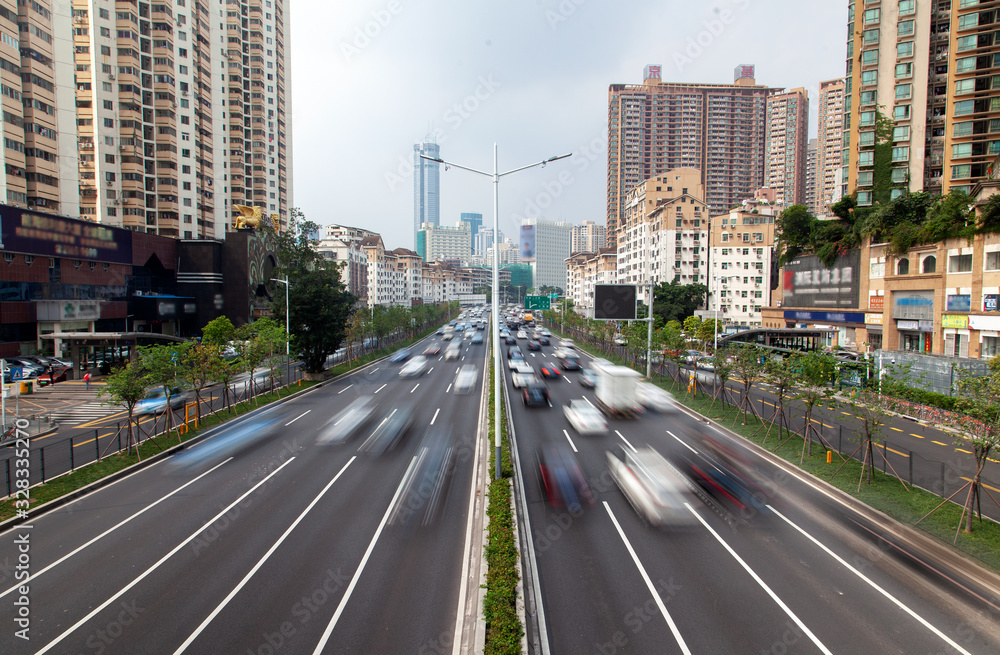 Shenzhen road with heavy traffic by city buildings Shenzhen road with heavy traffic by city buildings