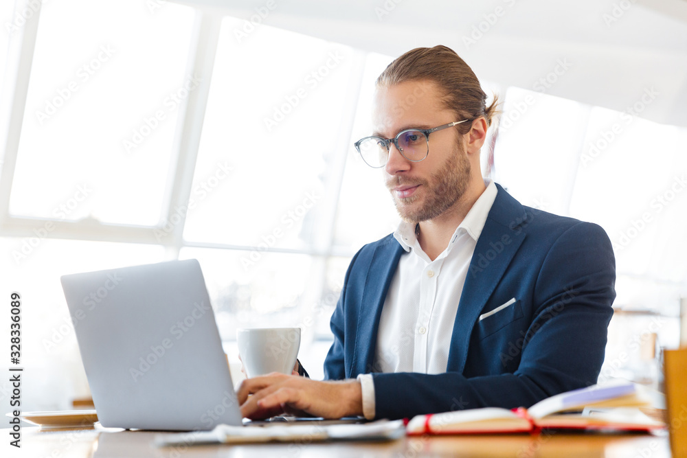 Concentrated young businessman using laptop computer. Concentrated young businessman using laptop computer.