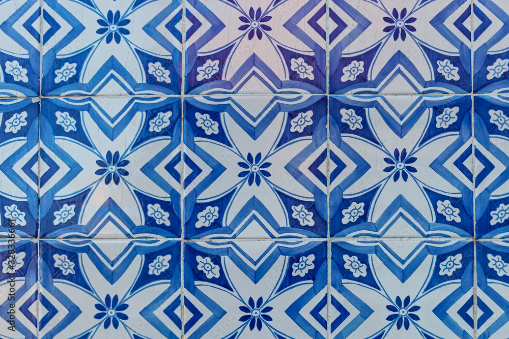 a fragment of the outer wall of a house in Lisbon decorated with ceramic tiles with a beautiful geometric pattern