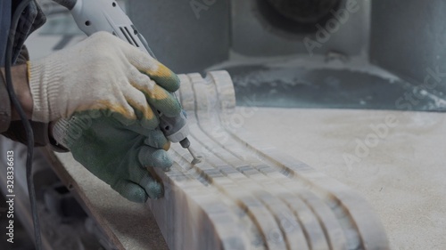 Engineer engraver working on a stone ornament plate, very neat work	