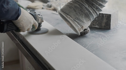 Senior sculptor removes the top layer of the marble plate