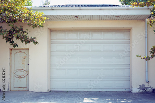 Shutter door or roller door and concrete floor outside .White Automatic shutters in a house . gates in the garage . Automatic Electric Roll-up Gate Or Push-up Door In The Modern Building .