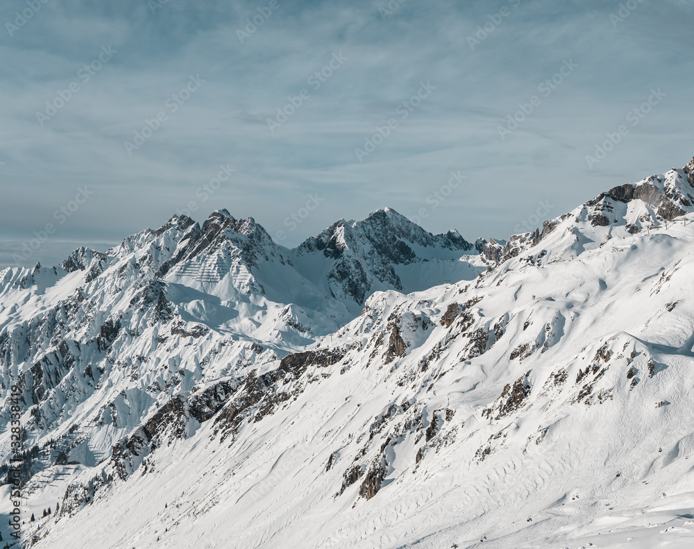 European winter sports Alps - snowy peaks, mountains and ski slopes with cloudy skies near St. Anton am Arlberg