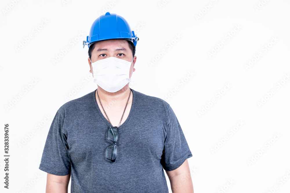 Portrait images of Asian male engineer are standing and wearing a mask On white background, concept to Health care and prevention of germs, such as PM 2.5, including flu or COVID-19 Portrait images of Asian male engineer are standing and wearing a mask On white background, concept to Health care and prevention of germs, such as PM 2.5, including flu or COVID-19