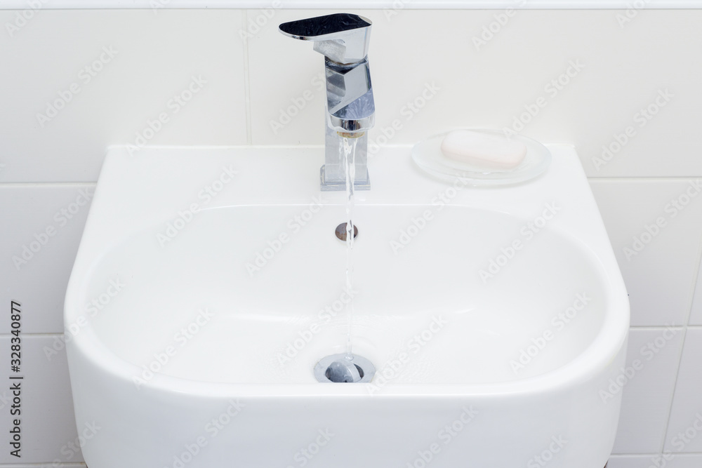 Fototapeta premium Modern bathroom sink in white home interior