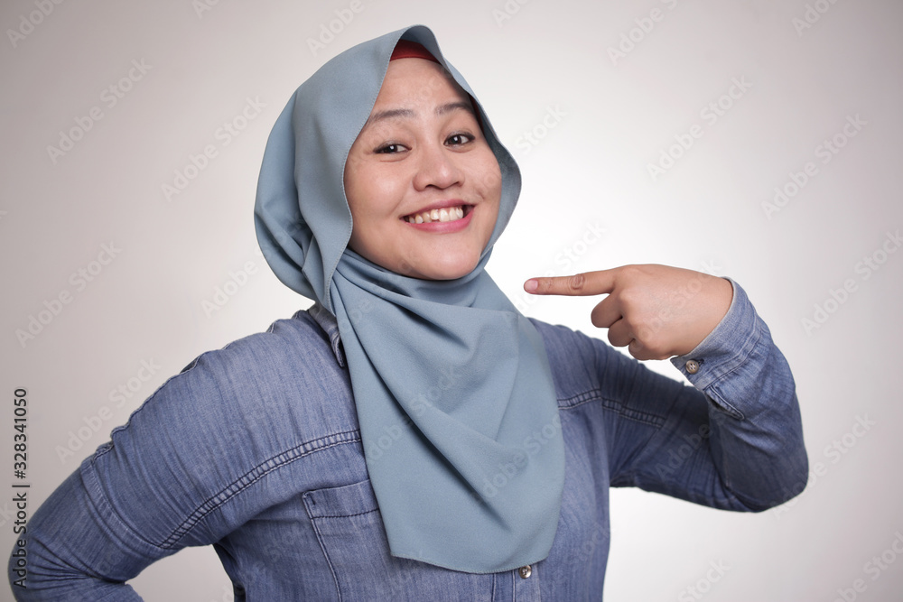 Confident Muslim Lady Smiling and Pointing Herself Confident Muslim Lady Smiling and Pointing Herself