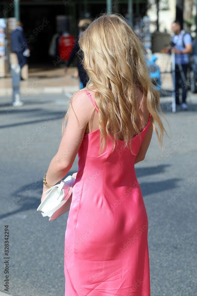 Cute Young Blond Woman Walking On The Street In Monaco, Monte-Carlo, Europe. Close Up Rear View