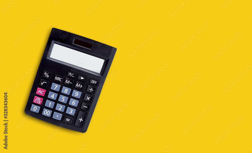Black calculator isolated on yellow background. Black calculator isolated on yellow background.