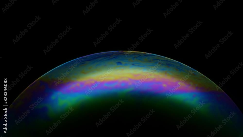 Close-up of soap bubble. Multicolored rainbow iris like colorful gas planet on black background. Abstract multi-colored surface overflows with abstract patterns Close-up of soap bubble. Multicolored rainbow iris like colorful gas planet on black background. Abstract multi-colored surface overflows with abstract patterns