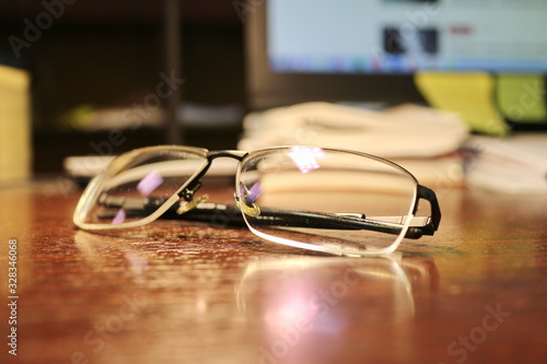 Glasses are on the office desk.