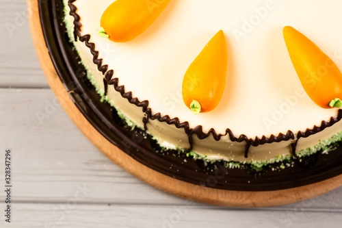 Homemade carrot cake with beautiful decor on wooden background photo