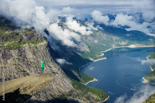 Young man jump on the edge Trolltunga. Norway © Hladchenko Viktor