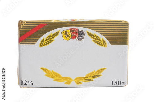 Stick of wrapped butter isolated on white background