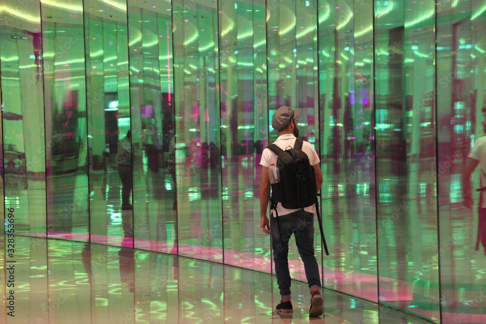 Man with backpack walking in a mall