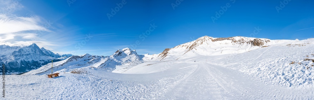 Wide parnoramic view of snow covered Swiss Alps in Grindelwald ski resort, Switzerland
