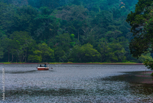 Beautiful boat ride through green nature heaven in Kerala freshwater lake in Wayanad, Indian travel and tourism image