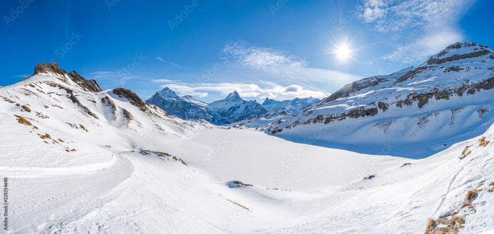 Wide parnoramic view of snow covered Swiss Alps in Grindelwald ski resort, Switzerland