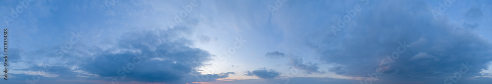 Large panorama of evening sunset sky with beautiful clouds.