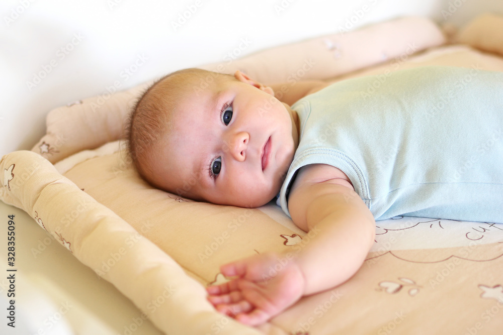 Newborn baby girl is lying on changing table. Newborn baby girl is lying on changing table.