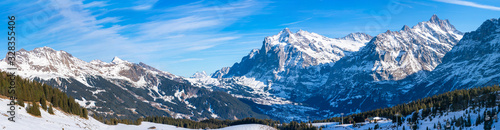 Wide parnoramic view of snow covered Swiss Alps in Grindelwald ski resort in the winter