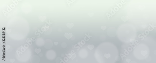 Abstract gray bokeh banner background with hearts - birthday, father's day, valentine's day panorama - blurry bokeh circles and hearts on a gray background.