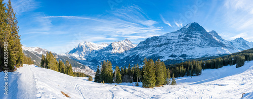 Wide parnoramic view of snow covered Swiss Alps in Grindelwald ski resort in the winter photo