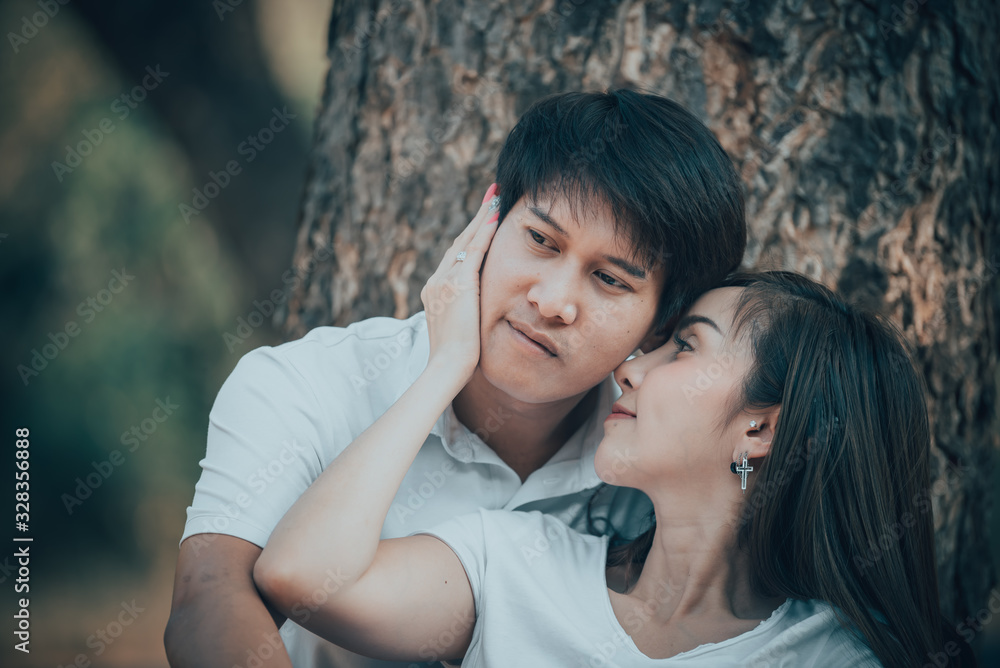 Portrait of young asian couple in love  in the forest,Thailand people happy to be together,Valentine day concept