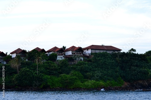 Several houses on top of the ocean shore