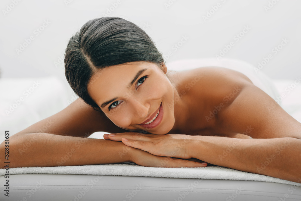 Beautiful woman enjoy relaxing on a massage table after anti-cellulite massage. Resort and spa Beautiful woman enjoy relaxing on a massage table after anti-cellulite massage. Resort and spa