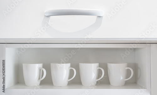 White coffee cups on the white shelf