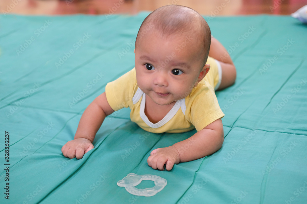 smile baby happy and crawling on soft green quilt. learning boy playing toy. smile baby happy and crawling on soft green quilt. learning boy playing toy.