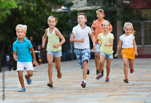 Group of children running outdoors in city street