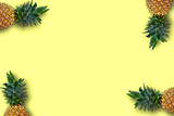 Ripe yellow pineapples isolated on yellow background. Copy blank space designed for your message.