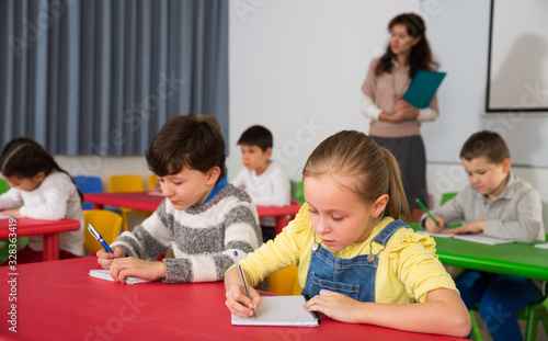Students writing at lessons
