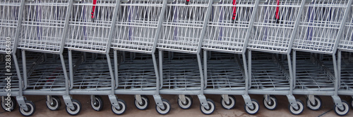 Close-up side view of a parade of shopping carts