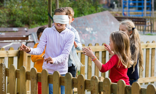 Laughing children playing at Blind man bluff photo