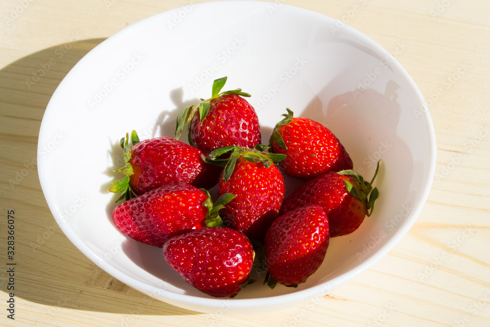 Bright strawberries on a white background, fruits and healthy food Bright strawberries on a white background, fruits and healthy food
