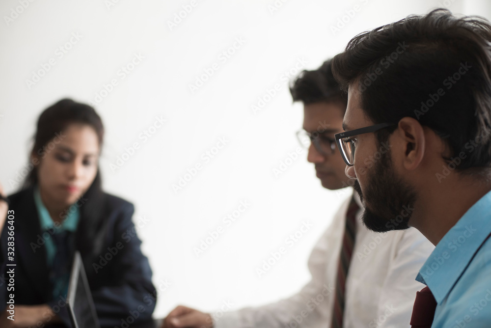 Young and energetic subordinates are discussing with female boss in Indian office. Indian corporate. Young and energetic subordinates are discussing with female boss in Indian office. Indian corporate.